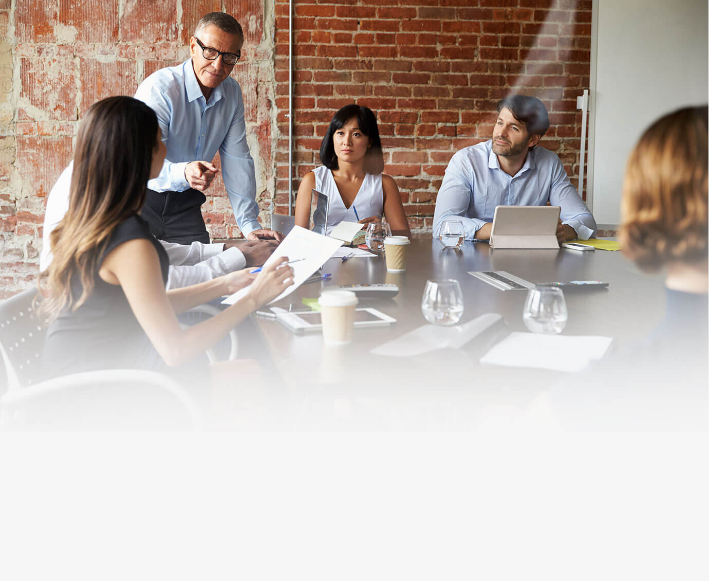 Businesspeople-Meeting-In-Modern-Boardroom-Through-Glass