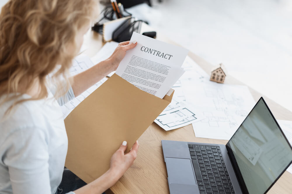 Businesswoman Working in Office, Takes the Document Out of the Envelope and Reading Contract, Sitting Behind Desk